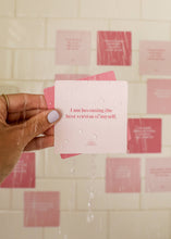 Load image into Gallery viewer, Hand holding a pink card with motivational text against a tiled wall.
