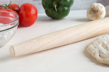 Load image into Gallery viewer, Wooden rolling pin on a white surface with tomatoes, bell pepper, and garlic in the background.
