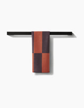 Load image into Gallery viewer, Color-blocked tie on a black rack against a white background
