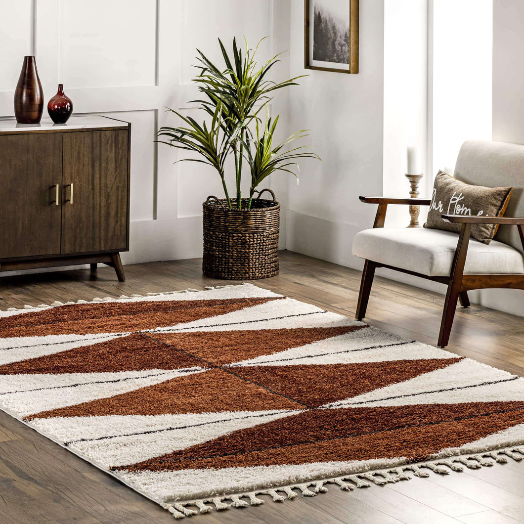 Living room with a patterned rug, wooden cabinet, and armchair.