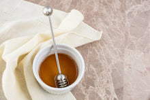 Load image into Gallery viewer, Honey in a white bowl with a honey dipper on a marble surface
