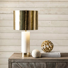 Load image into Gallery viewer, Decorative lamp with gold and white base on a wooden surface with books and a sphere.
