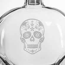 Load image into Gallery viewer, Clear glass bottle with a decorative skull design on a white background
