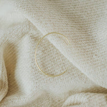 Load image into Gallery viewer, Gold bracelet on beige fabric
