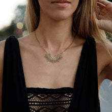 Load image into Gallery viewer, Woman wearing a black top with a gold necklace outdoors

