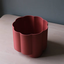 Load image into Gallery viewer, Red flower-shaped container on a light wooden surface with a gray background
