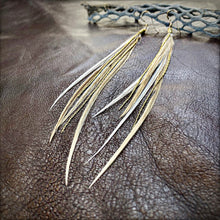 Load image into Gallery viewer, Feather earrings on a textured brown leather surface
