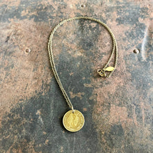 Load image into Gallery viewer, Gold necklace with a coin pendant on a textured surface
