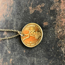 Load image into Gallery viewer, Gold coin pendant necklace on a dark textured surface
