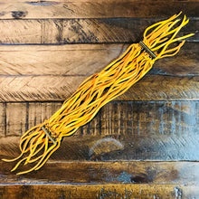 Load image into Gallery viewer, Yellow unfastened bracelet with metal clasps on a wooden surface
