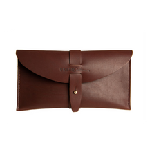 Load image into Gallery viewer, Brown leather clutch bag with a strap on a white background
