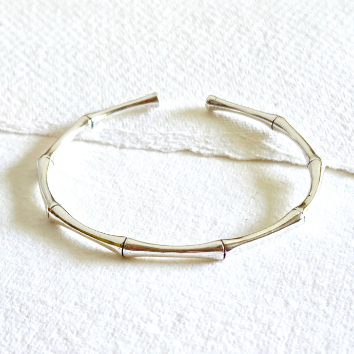 Silver bracelet on a textured white surface