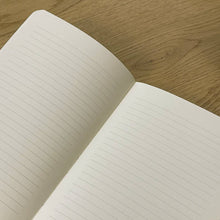 Load image into Gallery viewer, Open notebook with lined pages on a wooden surface
