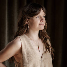 Load image into Gallery viewer, Woman wearing a beige sleeveless top with a dark background
