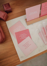 Load image into Gallery viewer, Set of pink cards with text on a wooden surface
