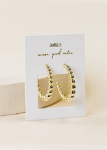Load image into Gallery viewer, Gold hoop earrings on a Jax &amp; Jazzy branded card with 'wear good vibes' text.
