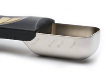 Load image into Gallery viewer, A stainless steel measuring scoop with a black handle, shown open on a white background. The scoop is marked with cup measurements including 1/2 cup, 1/3 cup, 1/4 cup, and 1/8 cup.
