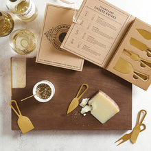 Load image into Gallery viewer, gold stainless steel cheese knives in a book box with a cheese board and wine
