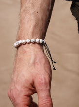 Load image into Gallery viewer, Close-up of a wrist wearing a beaded bracelet against a blurred background
