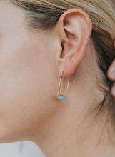 Load image into Gallery viewer, Close-up of an ear wearing a small hoop earring with a clear gemstone.
