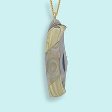 Load image into Gallery viewer, Gold and silver pendant on a light blue background
