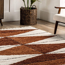 Load image into Gallery viewer, Geometric patterned rug with brown and white colors on a wooden floor.
