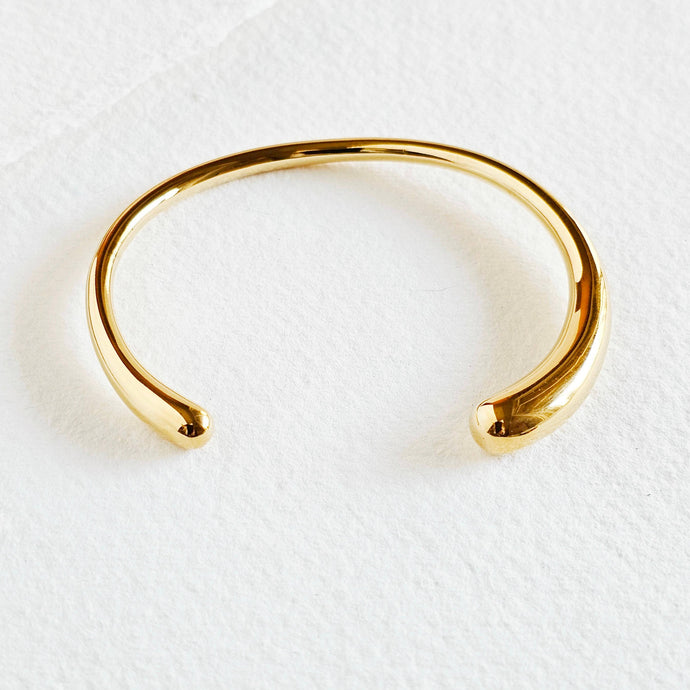 Bisjoux gold-plated cuff bangle bracelet on a white background