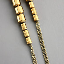 Load image into Gallery viewer, Gold brass beaded chain earrings in a close detail view on a gray background

