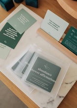 Load image into Gallery viewer, Shower affirmation cards with affirmations for the bath and shower focused on abundance shown with clear plastic envelope packaging
