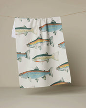 Load image into Gallery viewer, Tea towel with fish pattern hanging on a line against a beige background
