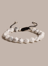 Load image into Gallery viewer, White beaded bracelet on a beige background
