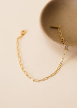 Load image into Gallery viewer, Gold chain bracelet on a beige surface

