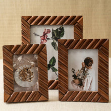Load image into Gallery viewer, Three wooden picture frames with different contents on a beige background
