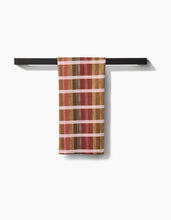 Load image into Gallery viewer, Striped towel hanging on a black rod against a white background
