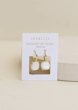 Load image into Gallery viewer, Jaxkelly earrings on a display card with a beige background
