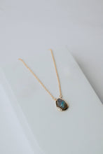 Load image into Gallery viewer, Necklace with a pendant on a light gray background
