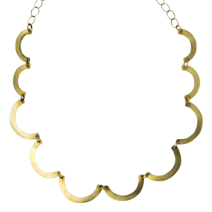 Gold necklace with C-shaped links on a white background