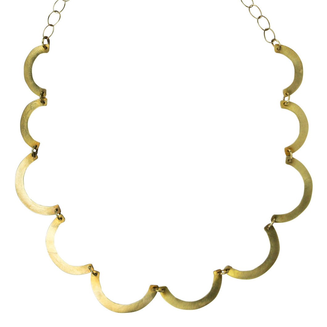 Gold necklace with C-shaped links on a white background