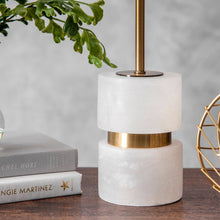 Load image into Gallery viewer, Decorative lamp with marble base and gold accents on a table with books and a plant.
