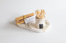 Load image into Gallery viewer, Palo Santo sticks in a decorative holder on a white surface
