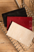 Load image into Gallery viewer, Three textured pouches in black, red, and beige on a metal surface.
