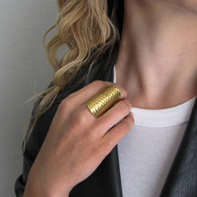 Load image into Gallery viewer, Person wearing a gold ring on a plain background
