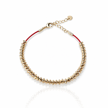 Load image into Gallery viewer, Gold bracelet with red cord on a white background
