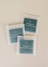 Load image into Gallery viewer, Shower affirmation cards with affirmations for the bath and shower focused on abundance shown with clear plastic envelope packaging
