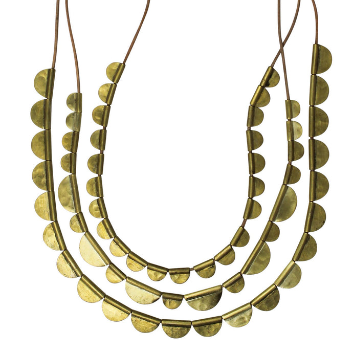 Three brass necklaces with circular pendants on a white background