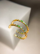 Load image into Gallery viewer, Gold ring with green and orange beads on a light background
