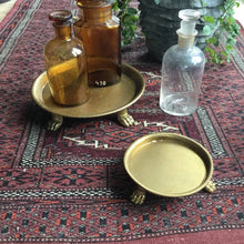 Load image into Gallery viewer, Vintage glass bottles on a footed round tray on a patterned rug
