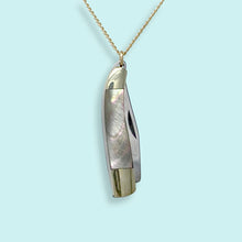 Load image into Gallery viewer, Gold and silver pendant on a light blue background
