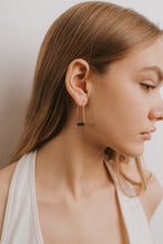 Load image into Gallery viewer, gold drop earring with black onyx stone worn in a woman&#39;s ear lobe
