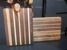 Load image into Gallery viewer, Two wooden cutting boards with striped pattern on a dark surface
